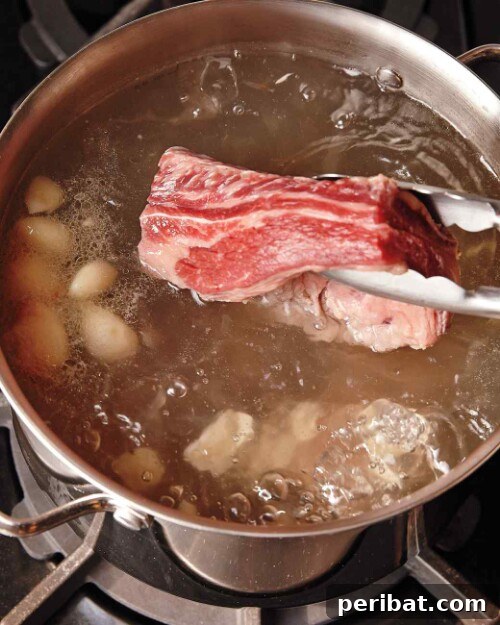 Grilling Game Changers Smart Hacks for Your Best BBQ Ever 18 Meat being boiled in a pot before grilling