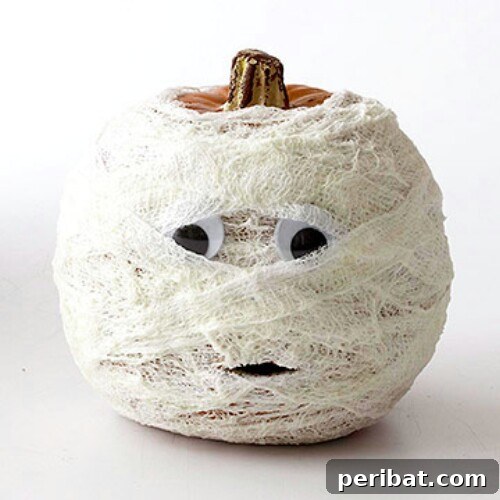 Mummy Pumpkin with minimal carving and googly eyes for Halloween fun