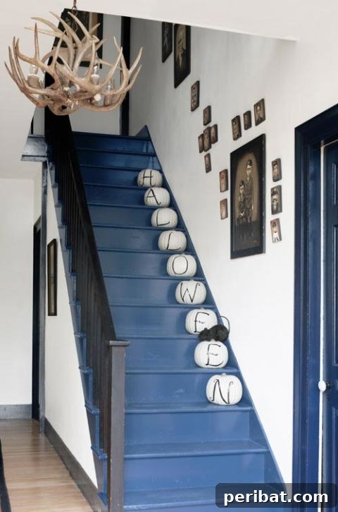 Pumpkins spelling 'Halloween' up a staircase, a simple but effective decoration