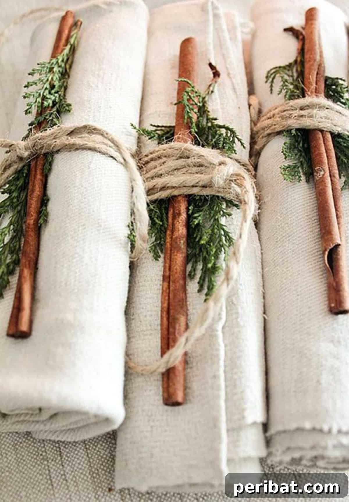 25 DIY Farmhouse Christmas Decor Ideas for a Rustic Country Christmas 15 Cinnamon Napkin Decorations with evergreen sprigs for an aromatic farmhouse Christmas table