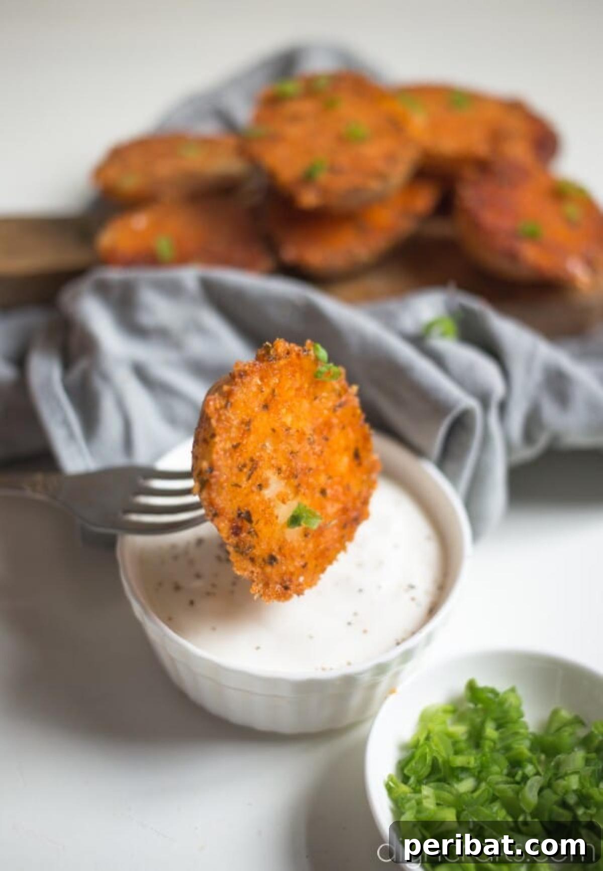 Dipping the crispy potato halves in sour cream and onion.