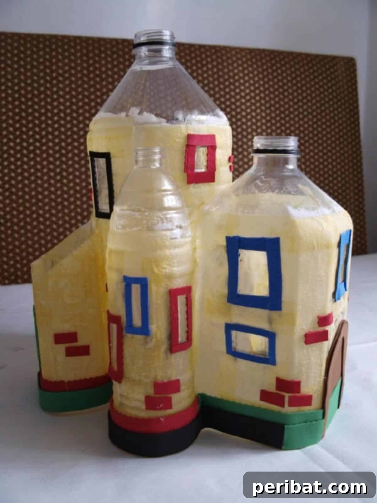 Unleash Magic: Build a Fairy Castle from Plastic Bottles 4 Attaching precisely cut craft foam pieces to outline windows, doorways, and create faux brick patterns and decorative trim on the textured plastic bottle structure.