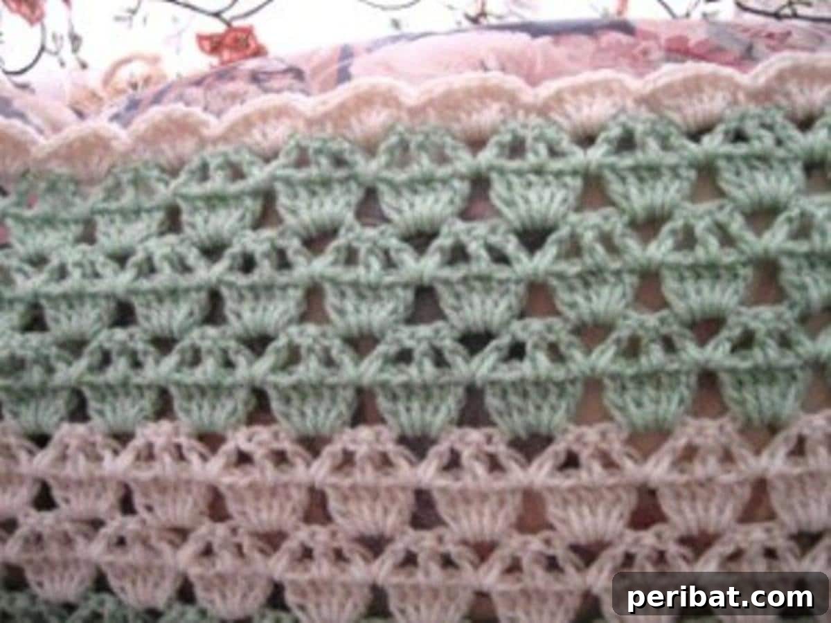Whip Up a Sweet Cupcake Afghan Your Little One Will Cherish 3 Close-up of the Cupcake Afghan showing intricate stitches and delicate pastel pink and green layers, evoking a sweet, frosted look.