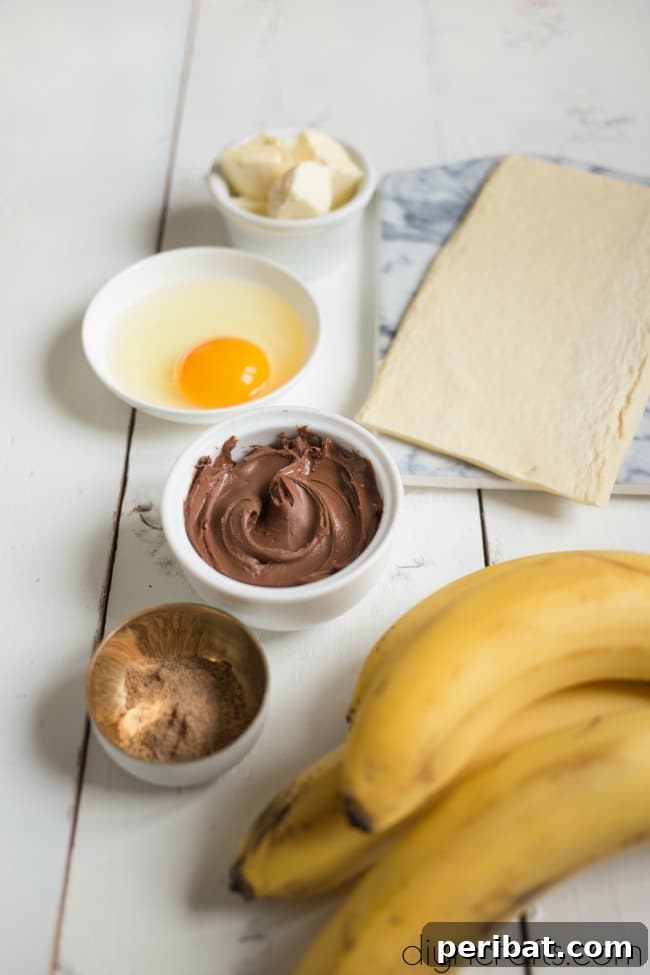 Ingredients for Banana and Nutella Stuffed Puff Pastry Rolls laid out on a table.