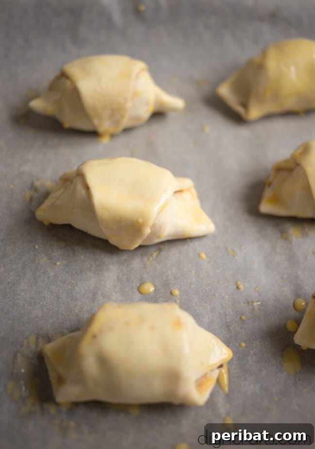Step 3: Spreading Nutella and placing banana on puff pastry triangles.