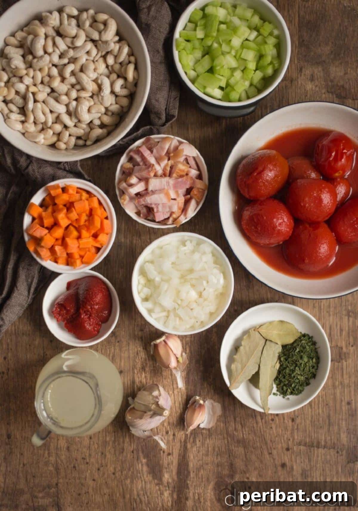 Hearty White Bean and Crispy Bacon Soup: Your Winter Blues Remedy 3 A vibrant display of fresh ingredients for white bean and crispy bacon soup, including white beans, bacon, carrots, celery, and tomatoes.