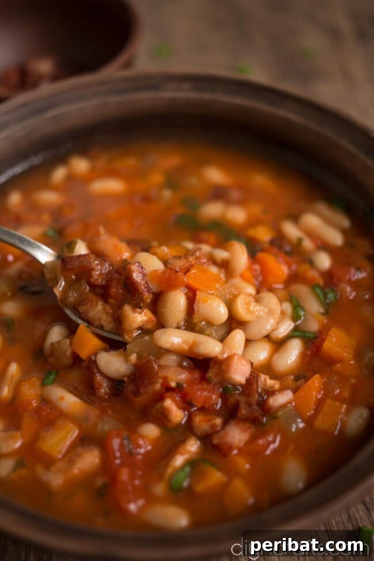 Hearty White Bean and Crispy Bacon Soup: Your Winter Blues Remedy 7 A close-up shot of a bowl of finished white bean and crispy bacon soup, garnished with fresh herbs and a swirl of cream.