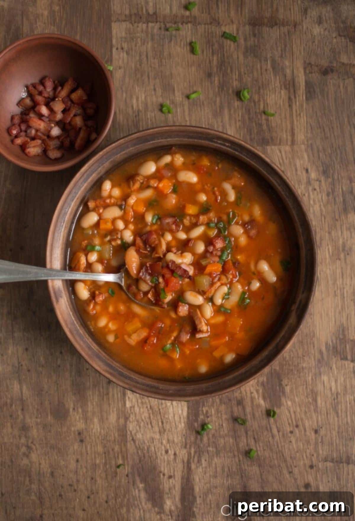 Hearty White Bean and Crispy Bacon Soup: Your Winter Blues Remedy 8 An overhead view of a rustic bowl of white bean and crispy bacon soup, perfect for a cozy meal.