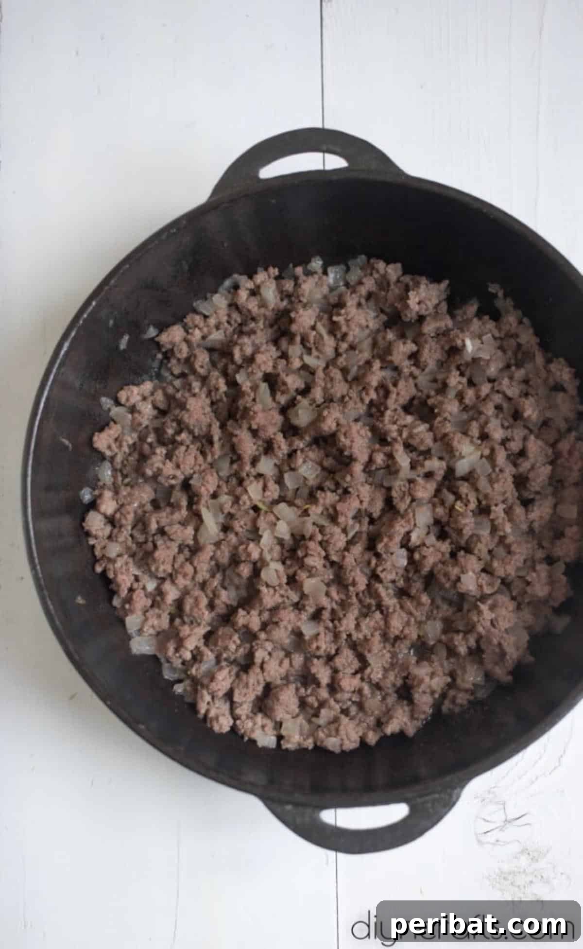 Golden Cheesy Cabbage Perfection 5 Browned ground beef with onion in a pan