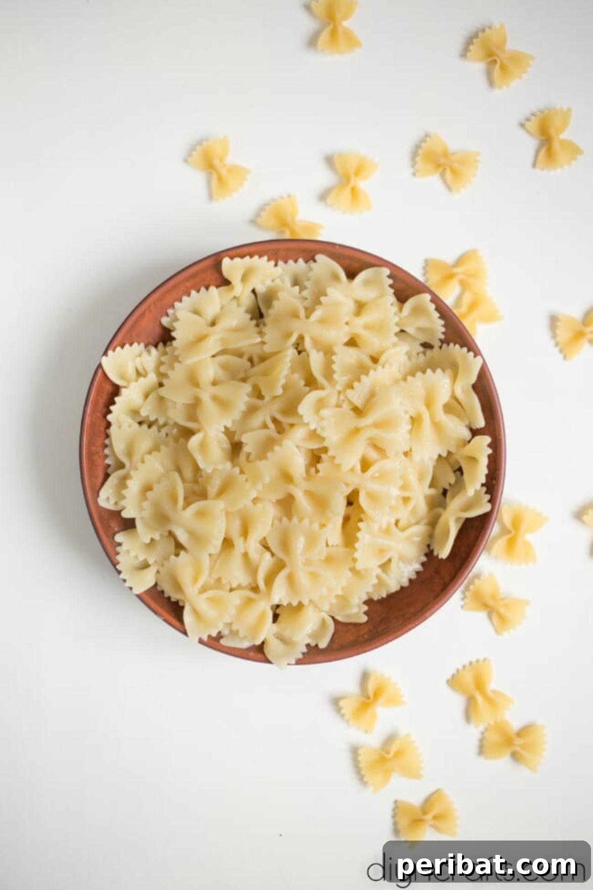 Irresistible BLT Pasta Salad: Recipe Requests Guaranteed 6 Cooked bow-tie pasta in a bowl, ready to be mixed with other ingredients.