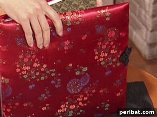 Quilted photo album cover made from pieces of baby clothing