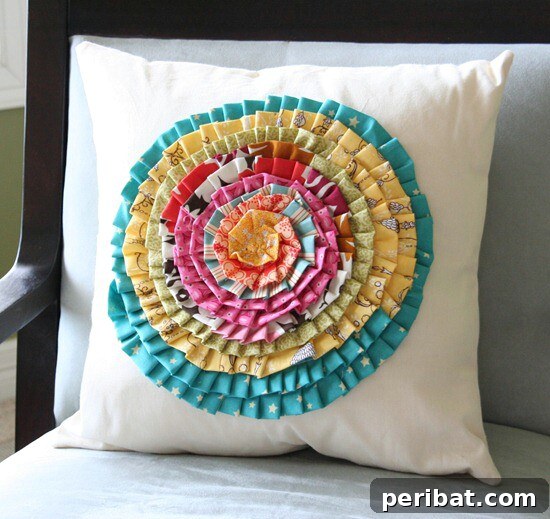 Decorative pillow adorned with patterns cut from old baby clothes
