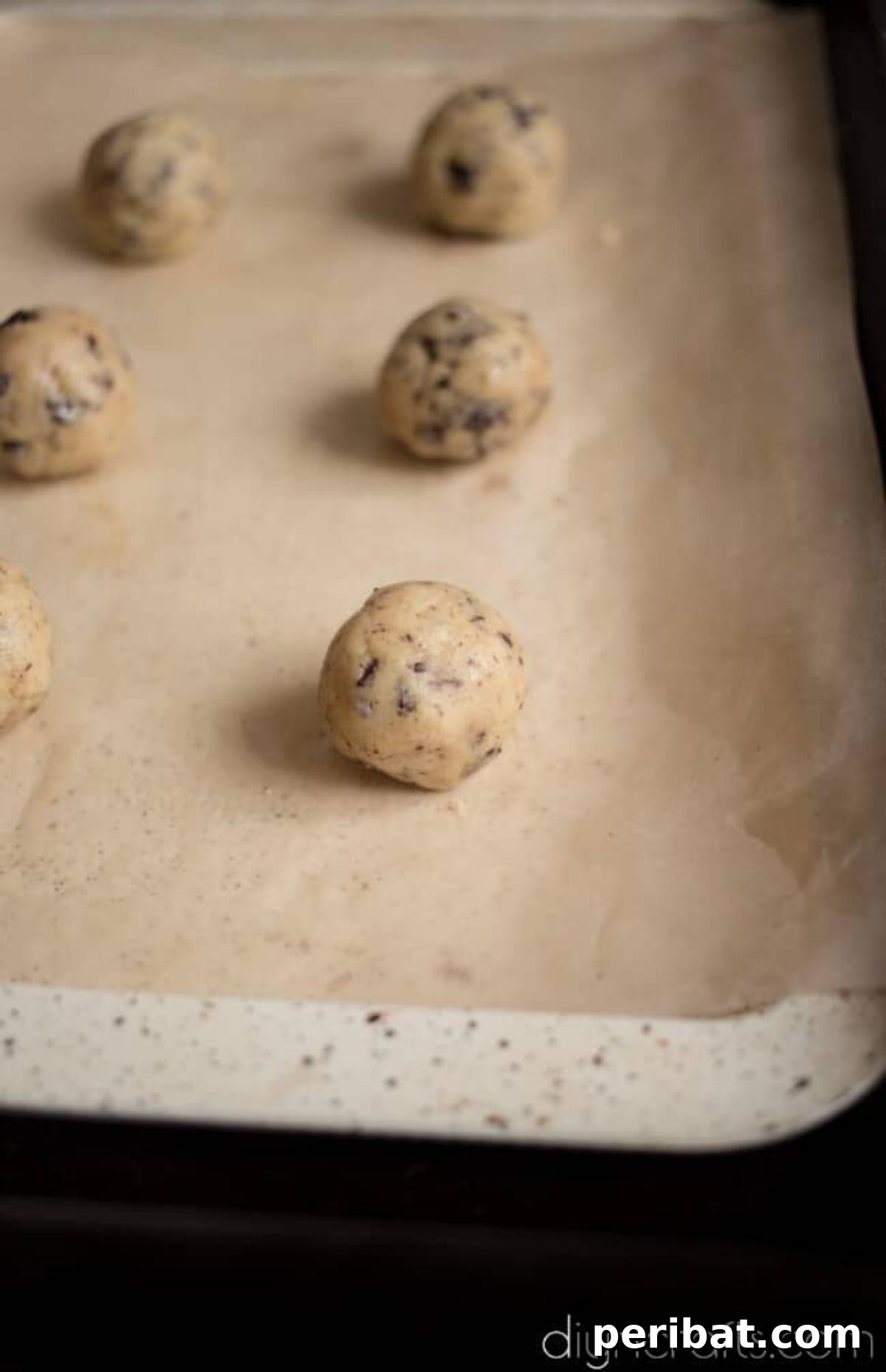 Timeless Delight: Effortless Chocolate Chip Cookies 6 Rolling cookie dough into small balls before baking.