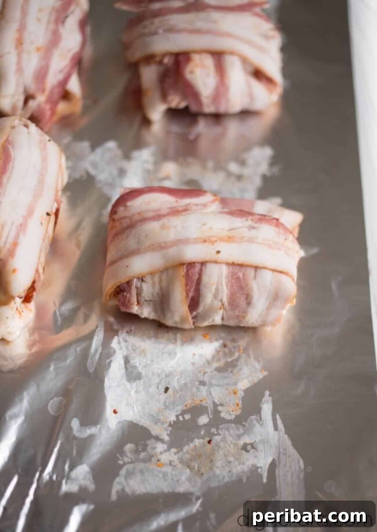 Decadent Bacon Wrapped Cheese Stuffed Chicken Thighs 8 Bacon being expertly wrapped around the stuffed chicken thighs.