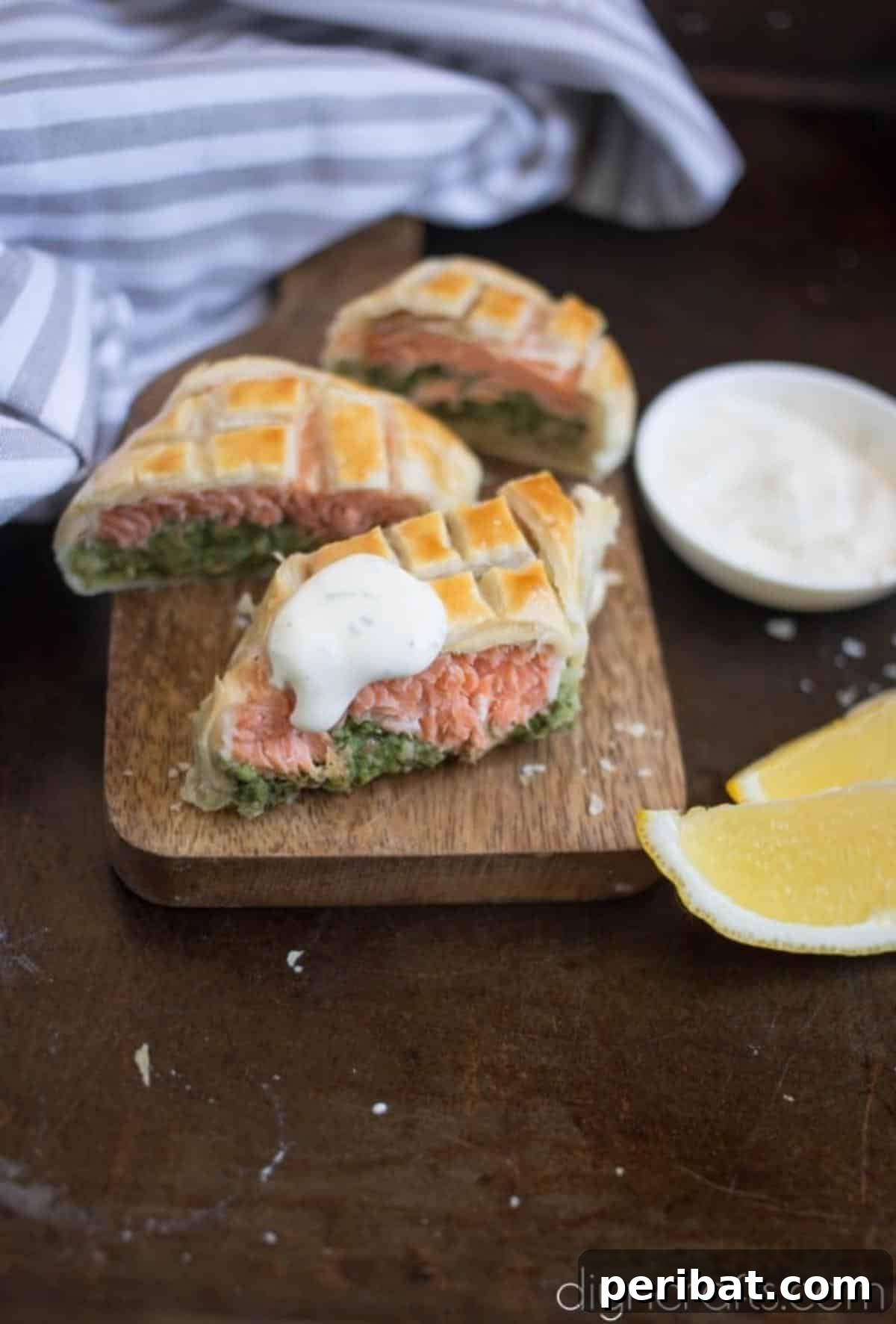 Elevate Your Brunch: Light Salmon Wellington Perfection 7 Finished Salmon Wellington on a serving plate, golden brown and flaky, garnished with fresh herbs and a side of sauce.