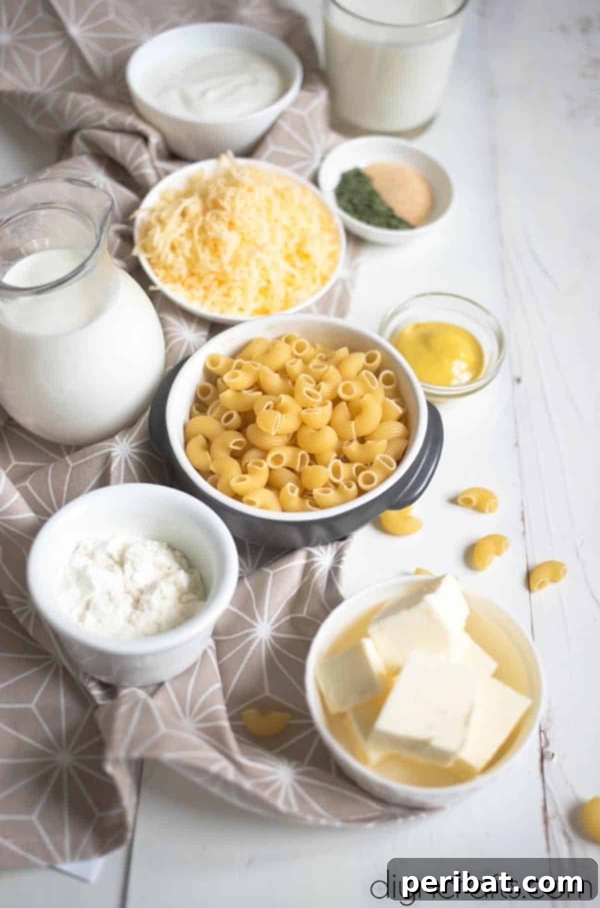 The Ultimate Decadent Mac and Cheese 3 A bowl of fresh ingredients for Million Dollar Macaroni and Cheese, including various cheeses, pasta, and seasonings.