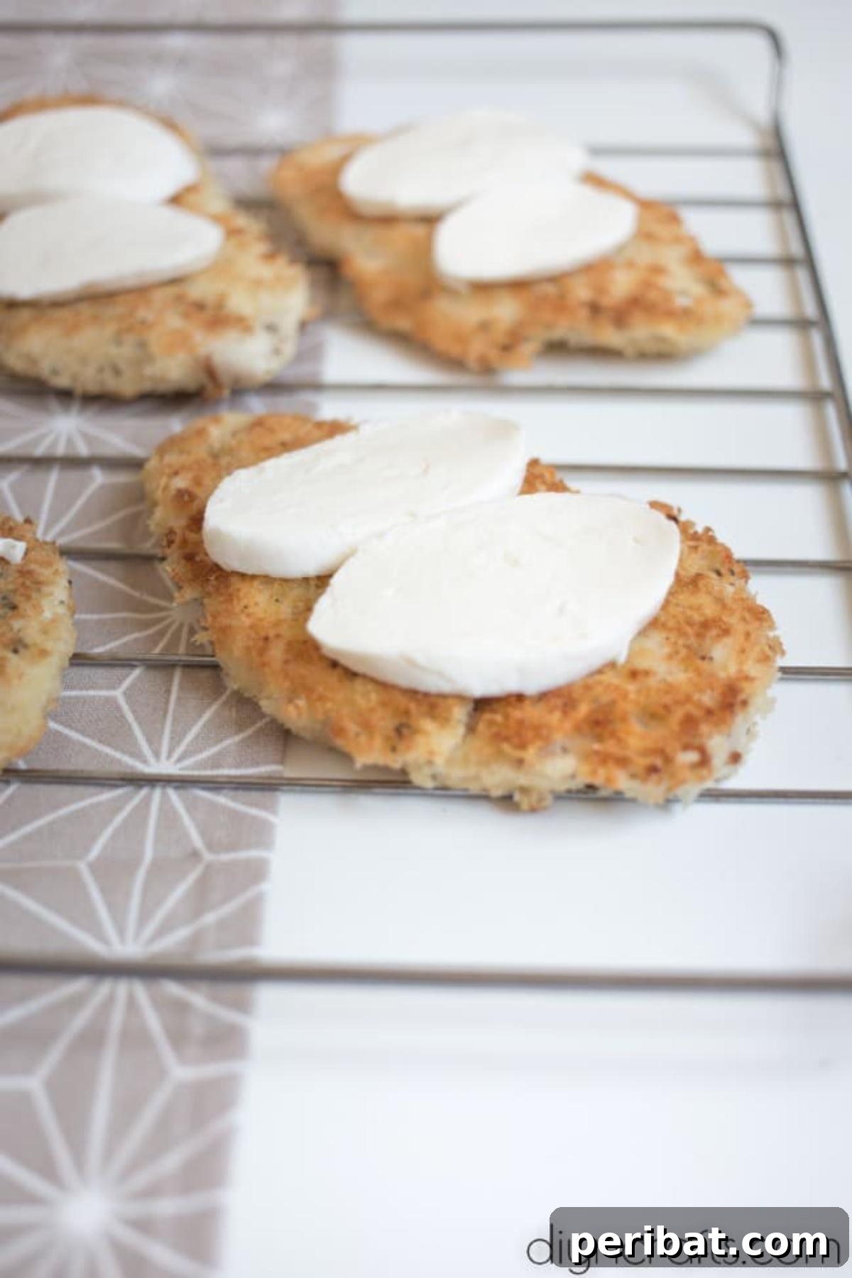 Adding sliced mozzarella.