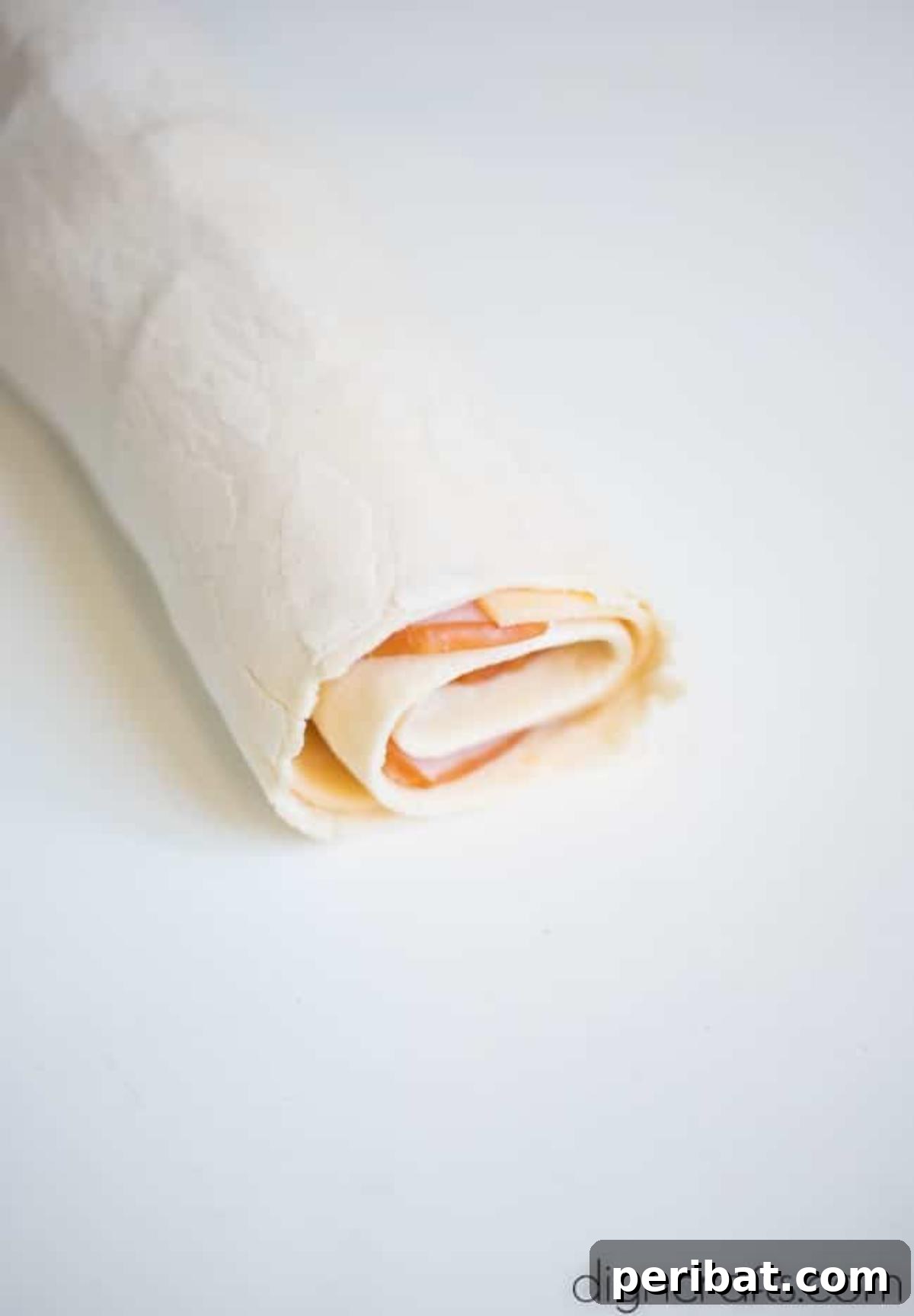Baked Ham and Cheese Roll Ups Reimagined 5 Cheese and ham rolled up.