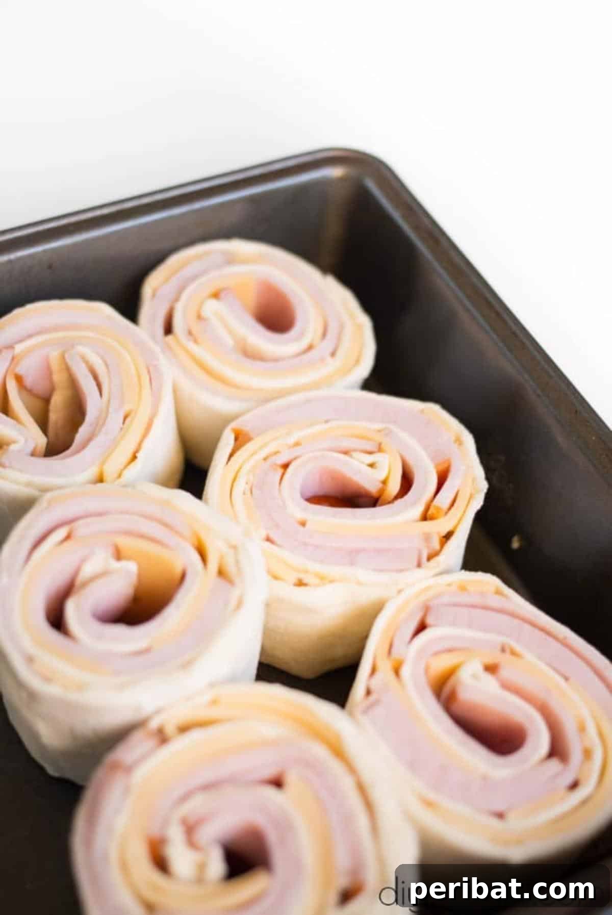 Baked Ham and Cheese Roll Ups Reimagined 6 Sliced bacon and cheese roll ups.