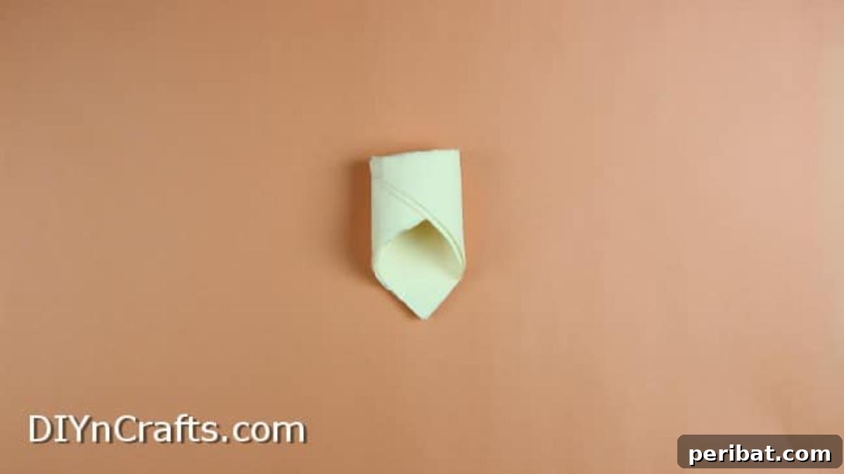 Effortless Adorable Easter Bunny Napkin Place Settings 11 Pulling in and taping the corners of the folded napkin to create the basket shape.