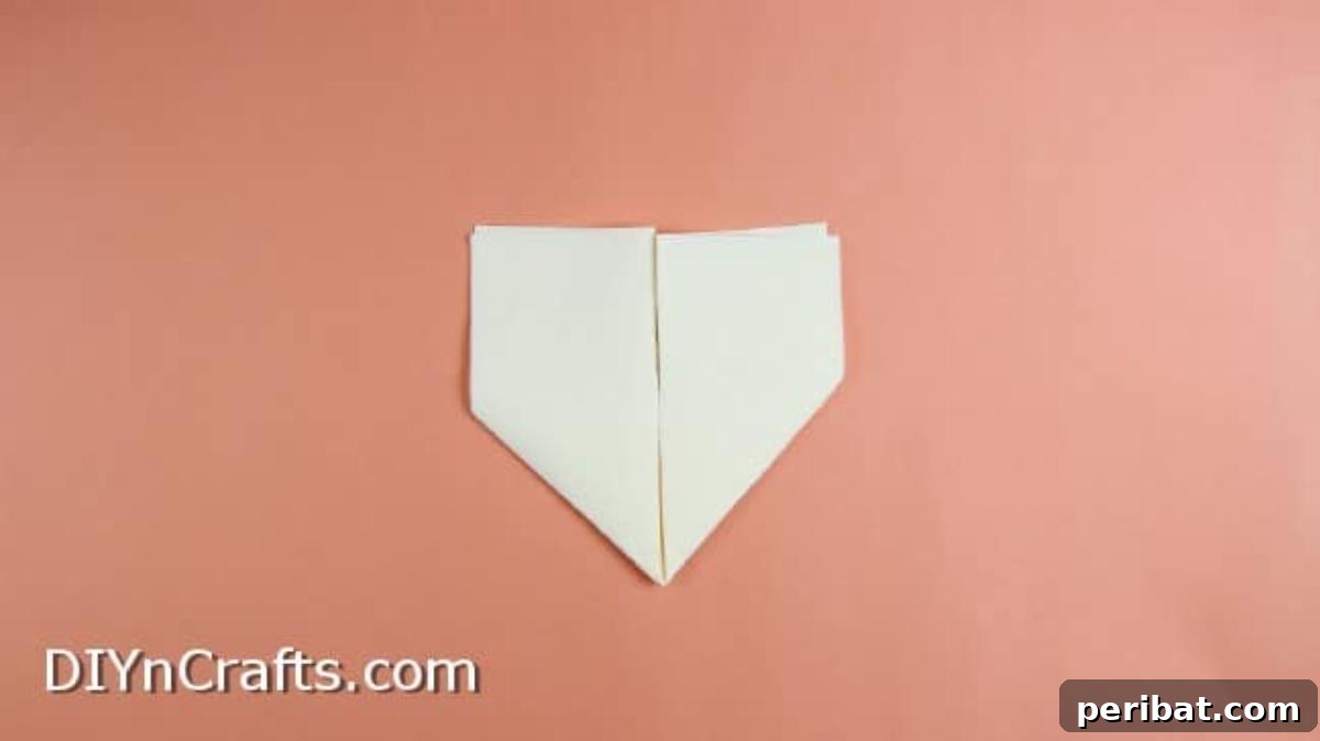 Effortless Adorable Easter Bunny Napkin Place Settings 5 Folding both sides of the napkin inwards along the centerline for the bunny.