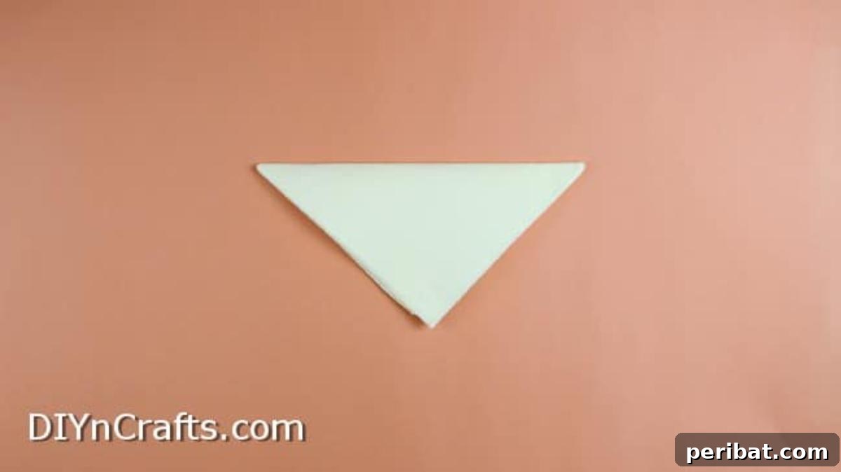 Effortless Adorable Easter Bunny Napkin Place Settings 10 Folding a square napkin diagonally to form a triangle for the basket.