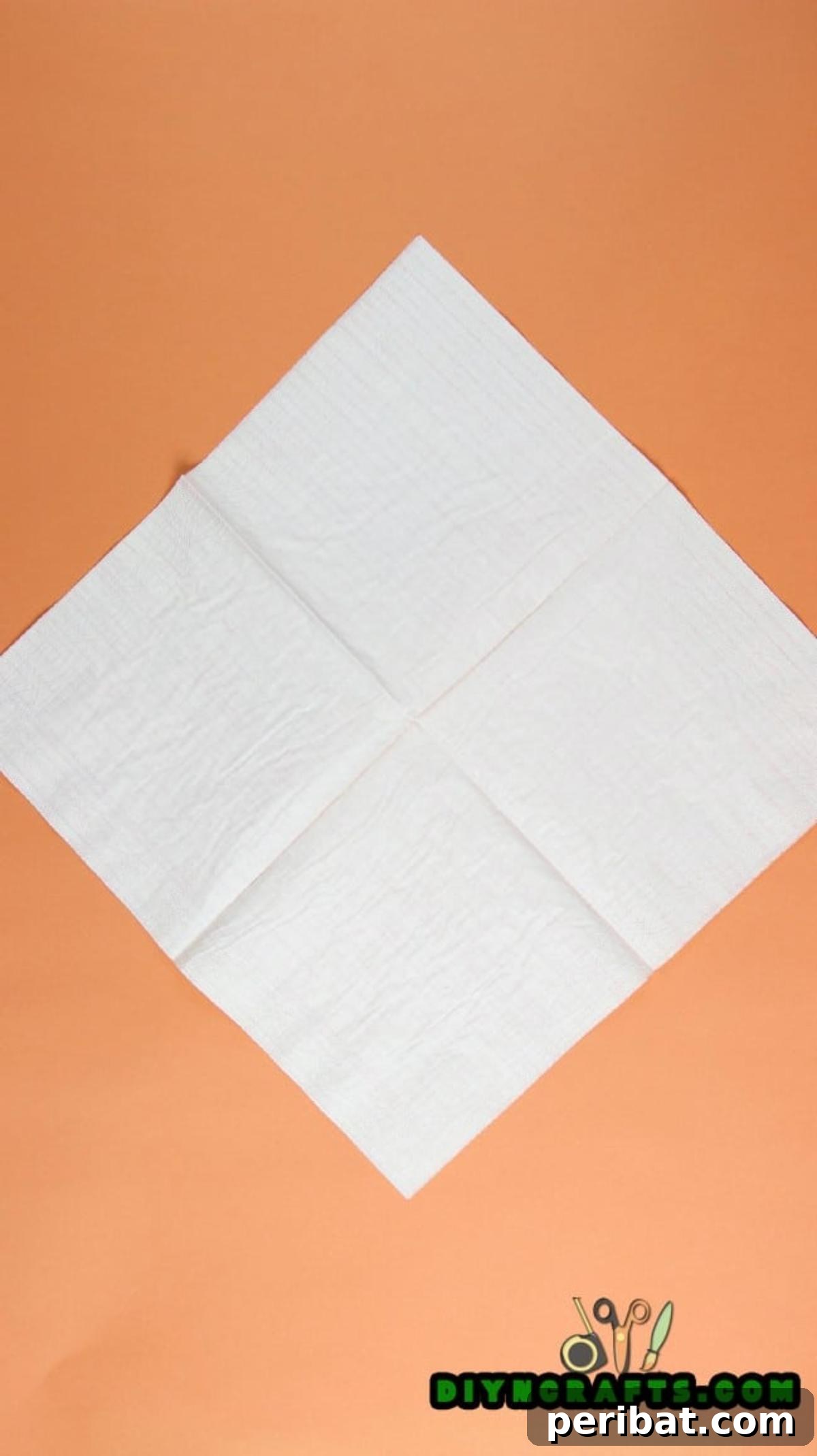 Sweet and Simple Easter Table Decor 3 Square paper napkin with horizontal and vertical creases, forming a central cross shape.