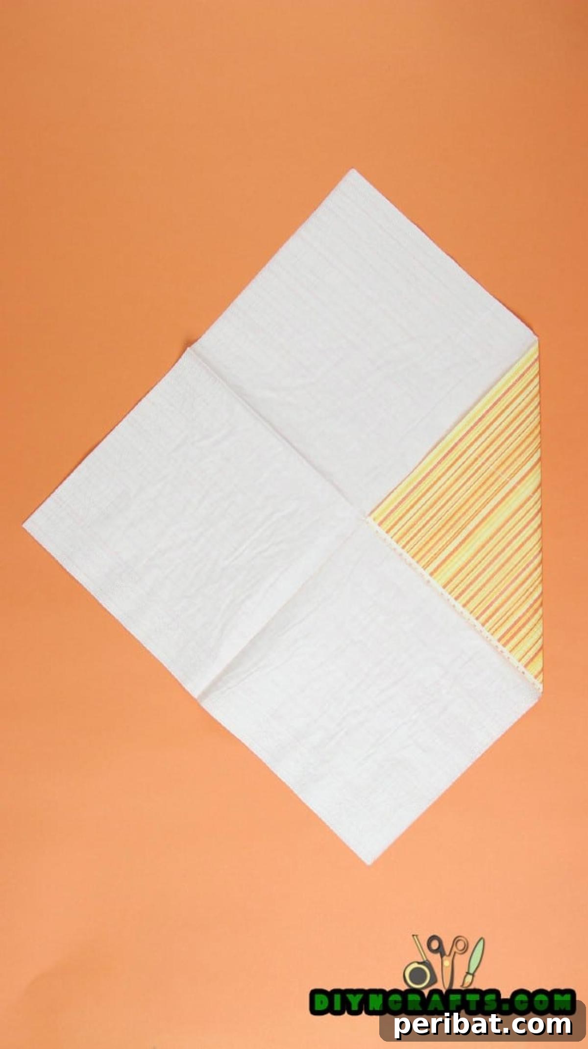 Sweet and Simple Easter Table Decor 4 All four corners of the napkin folded inward to meet at the center, forming a smaller square.