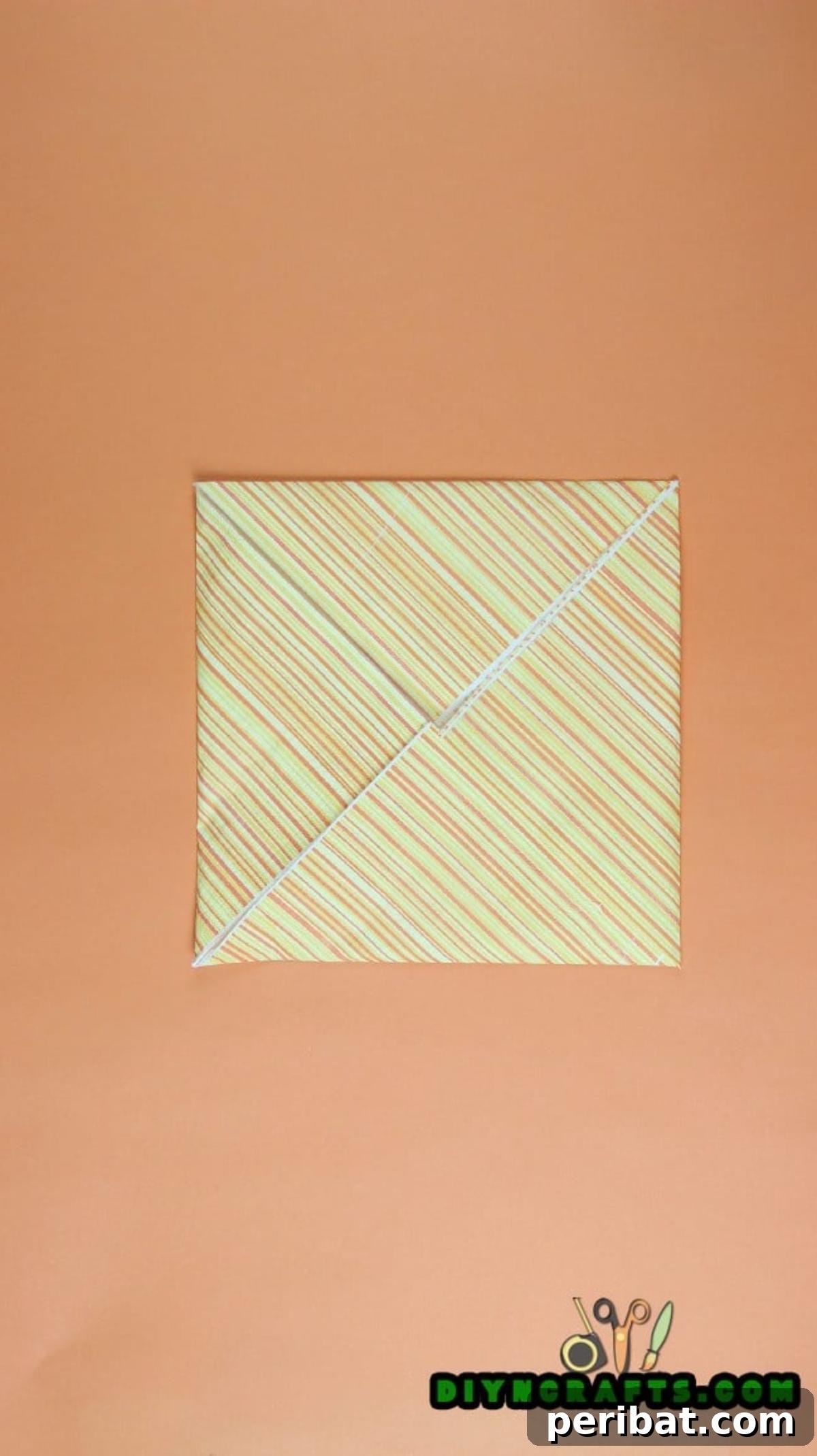 Sweet and Simple Easter Table Decor 5 Close-up of the napkin after the first set of corner folds, showing the compact square shape.
