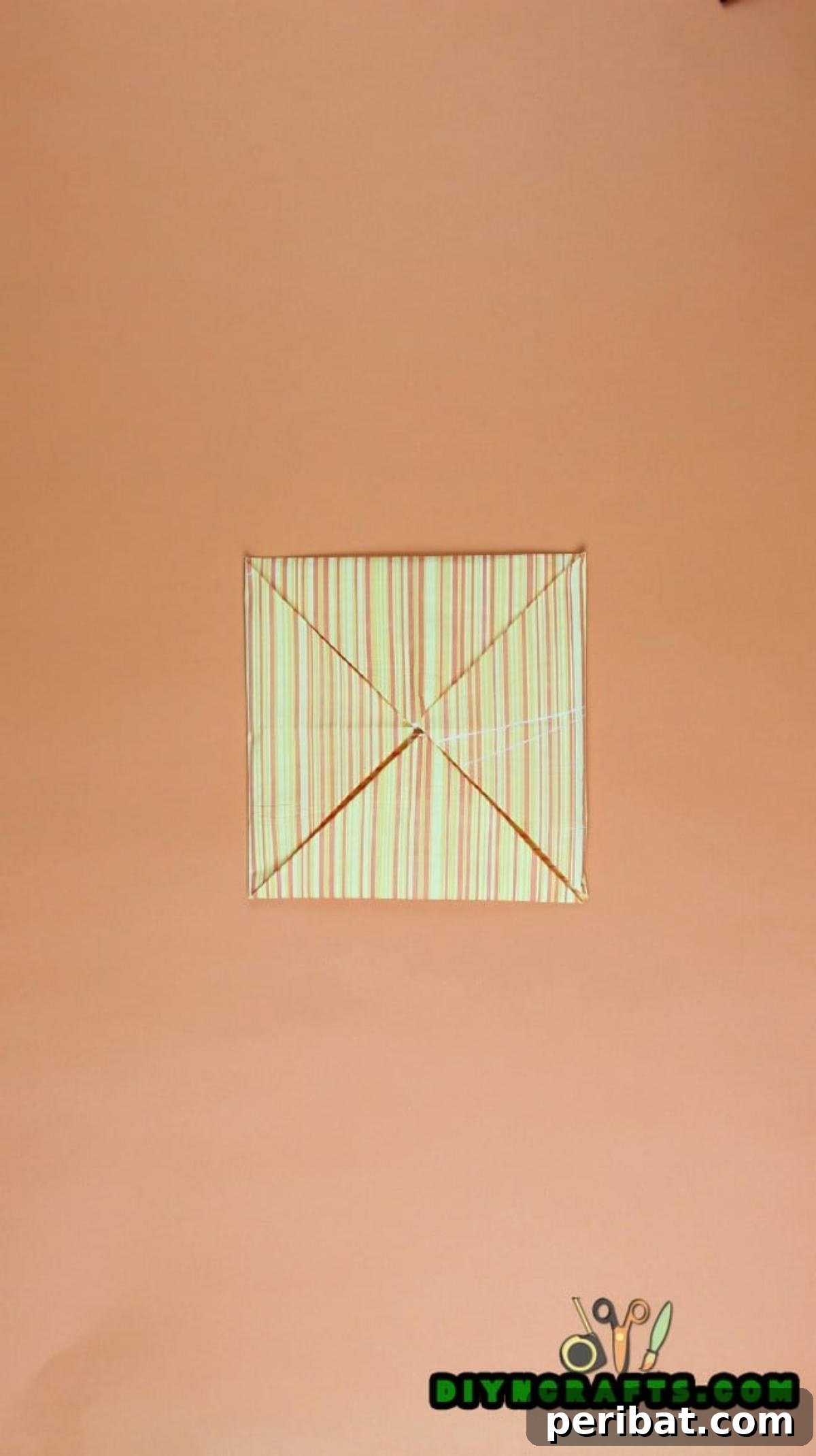 Sweet and Simple Easter Table Decor 7 Detailed view of the napkin after the second series of corner folds, emphasizing the compact form.