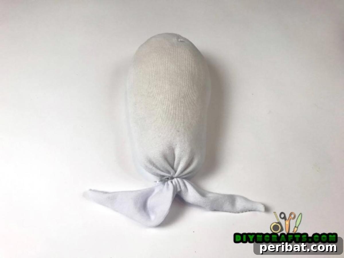 Make an Adorable Easter Bunny with an Old Sock 4 Step 1 - Filling the sock with rice for your DIY Easter bunny craft.