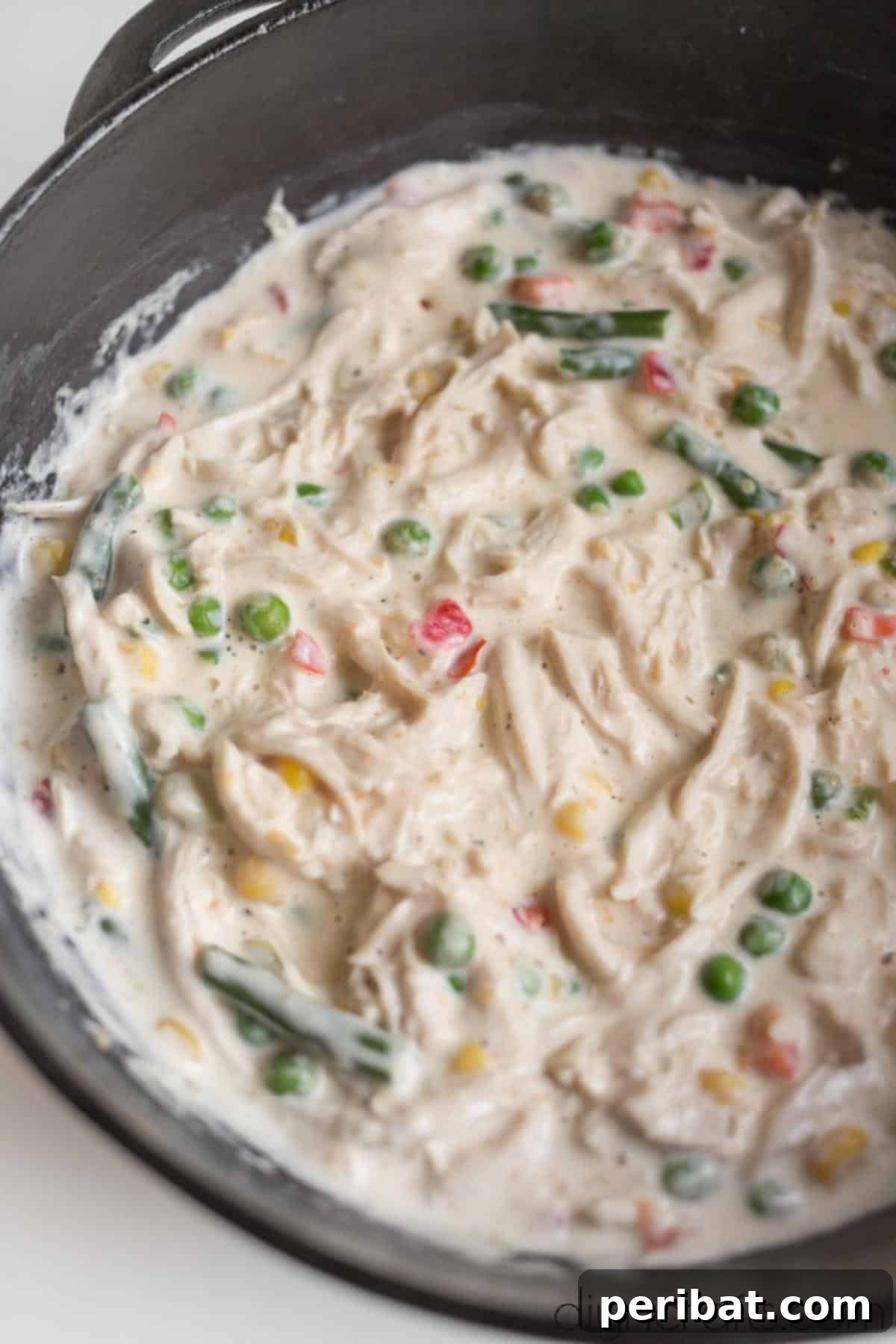 Effortless Cast Iron Skillet Chicken Pot Pie Family Favorite 5 Combining all ingredients for cast iron chicken pot pie