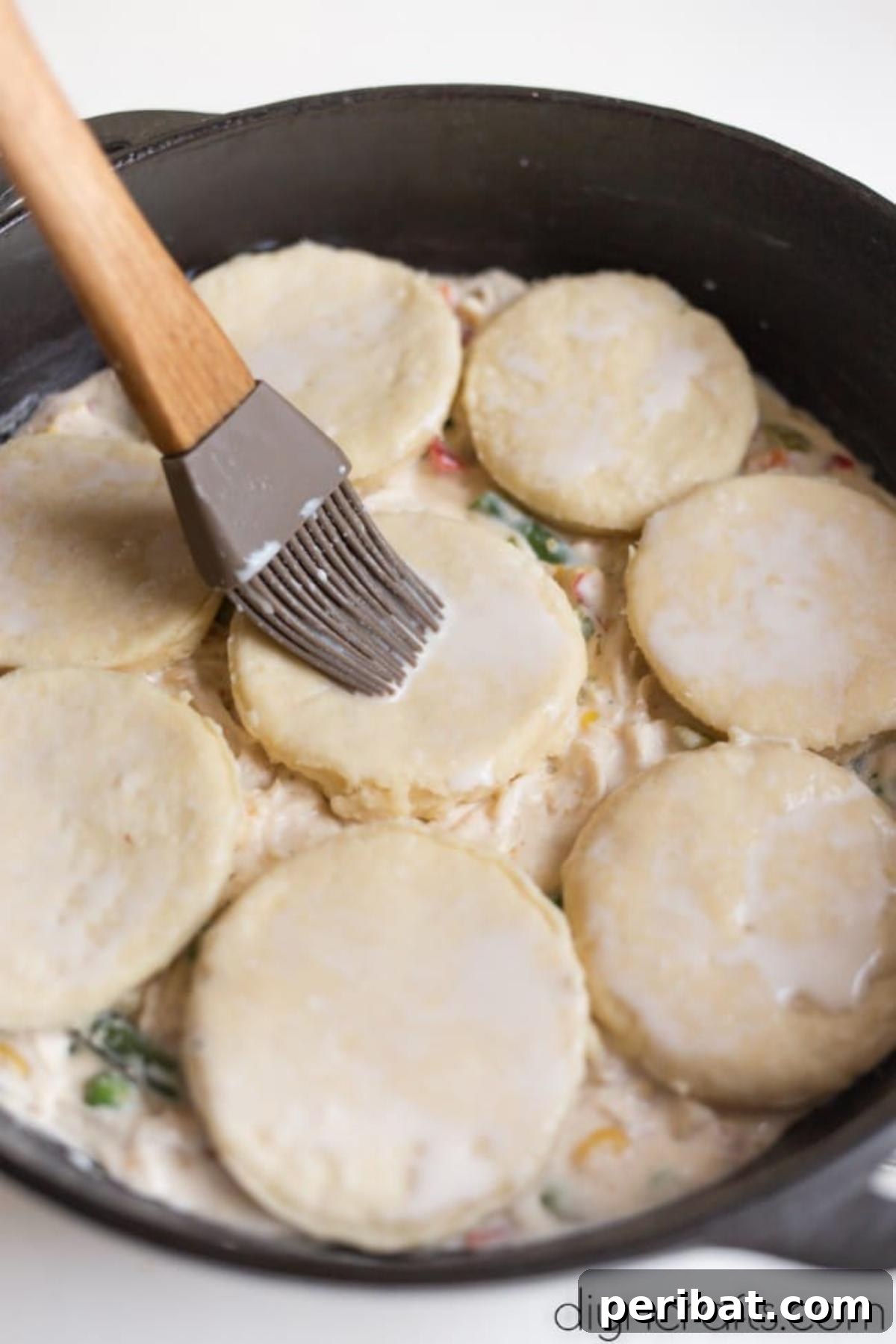 Effortless Cast Iron Skillet Chicken Pot Pie Family Favorite 6 Adding buttermilk biscuits to the top of the chicken pot pie filling