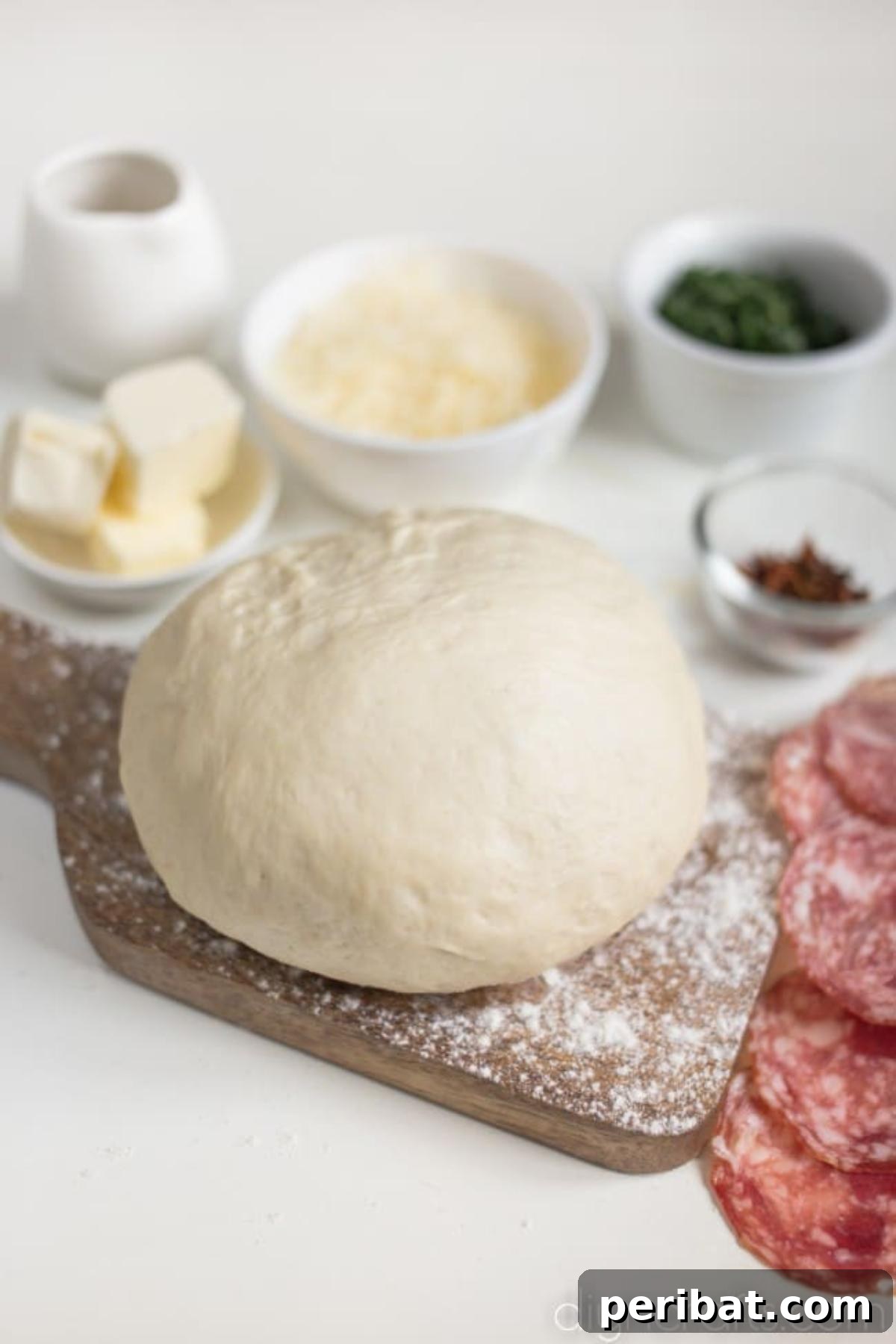 Pull-Apart Pepperoni Garlic Knots: Pure Appetizer Perfection 3 Pizza dough rolled out and cut into strips, ready to be tied into knots.