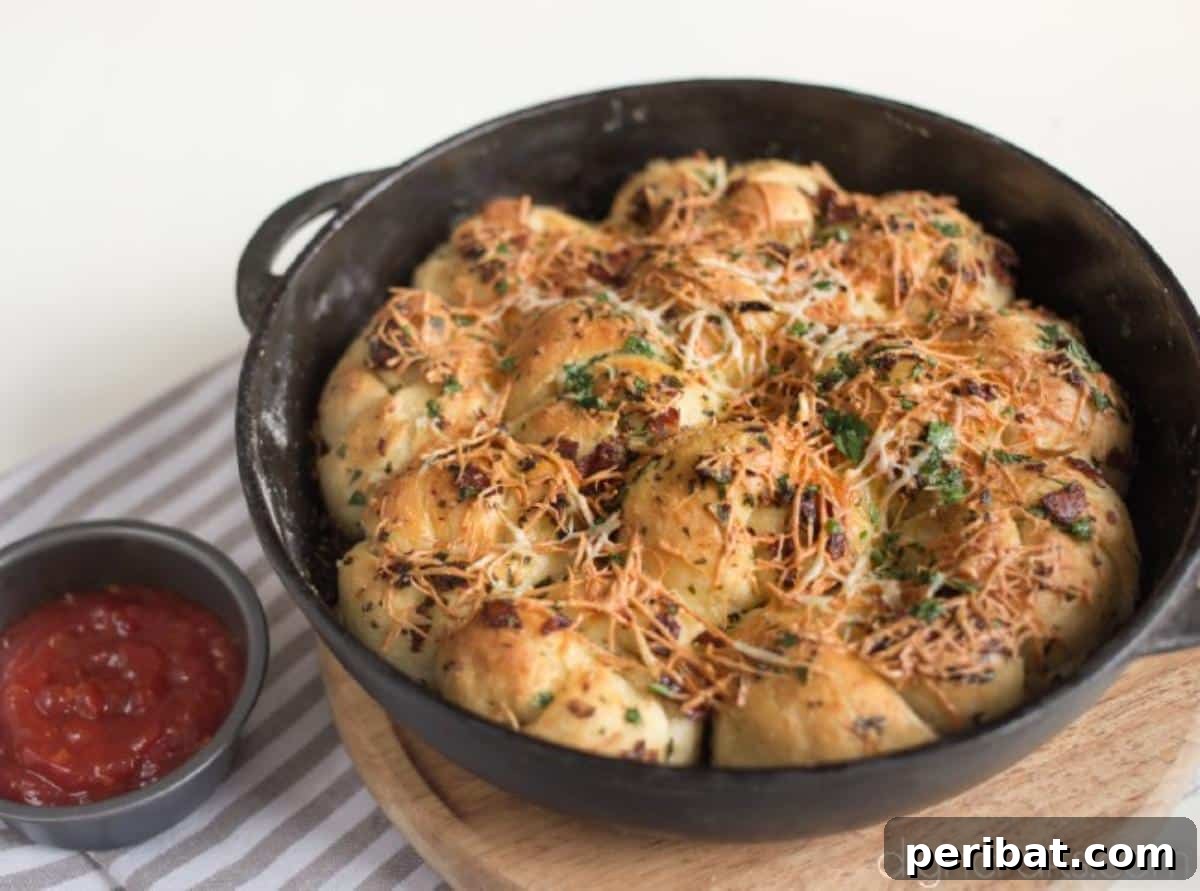 Pull-Apart Pepperoni Garlic Knots: Pure Appetizer Perfection 7 Freshly baked pull-apart pepperoni garlic knots with melted cheese and a golden crust in a cast iron skillet.