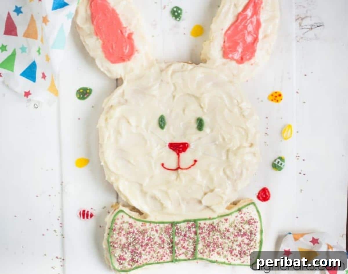 Hem Şirin Hem Lezzetli Paskalya Tavşanı Pastası Tarifi 9 A partially decorated Easter Bunny cake, with sprinkles and colored icing adding personality to its face and bow tie. This step brings the charming character to life with vibrant details.