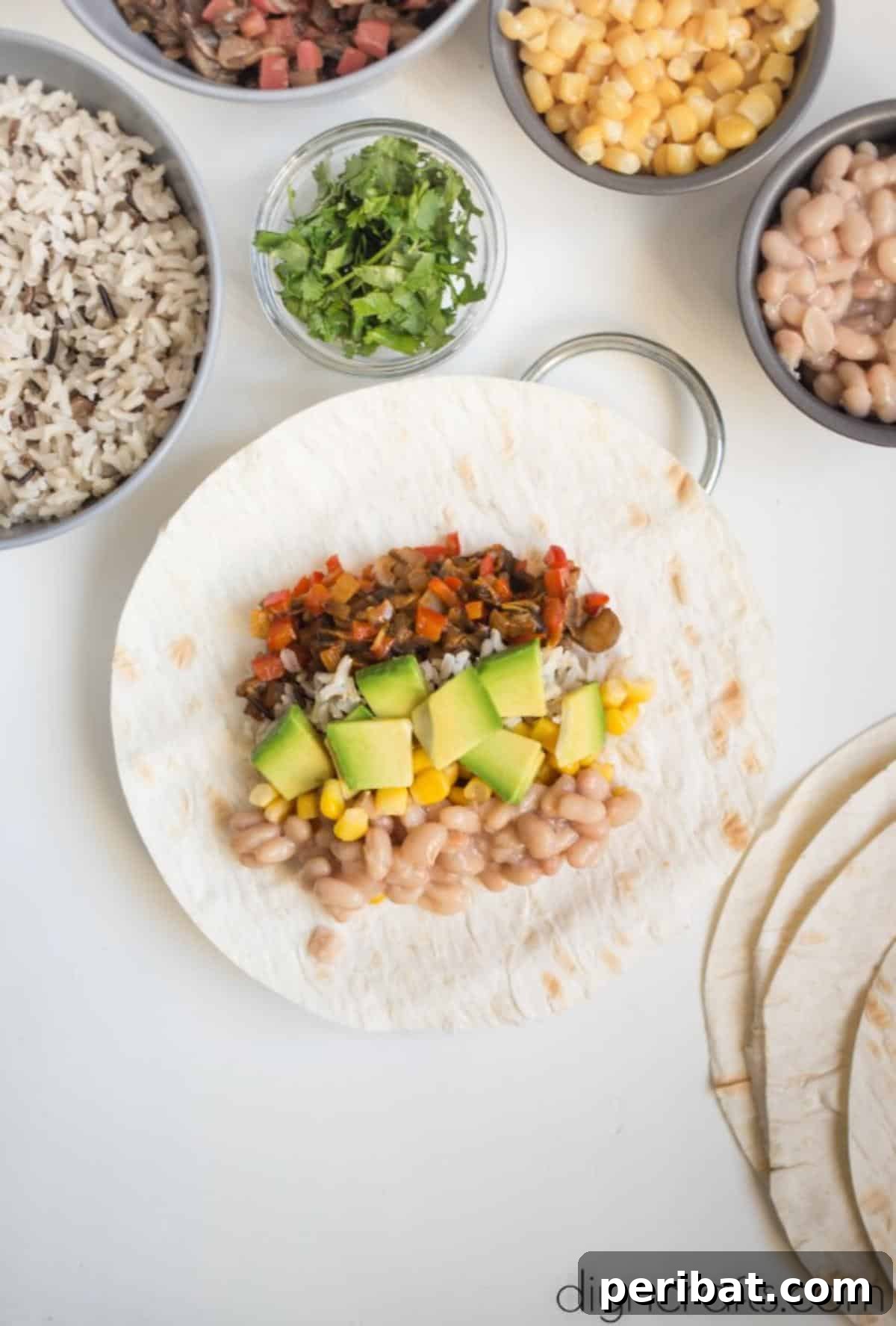 Vegan Burrito Power: High-Protein, Low-Fat Snacking Perfected 6 Layering delicious vegan filling and avocado slices onto a tortilla.