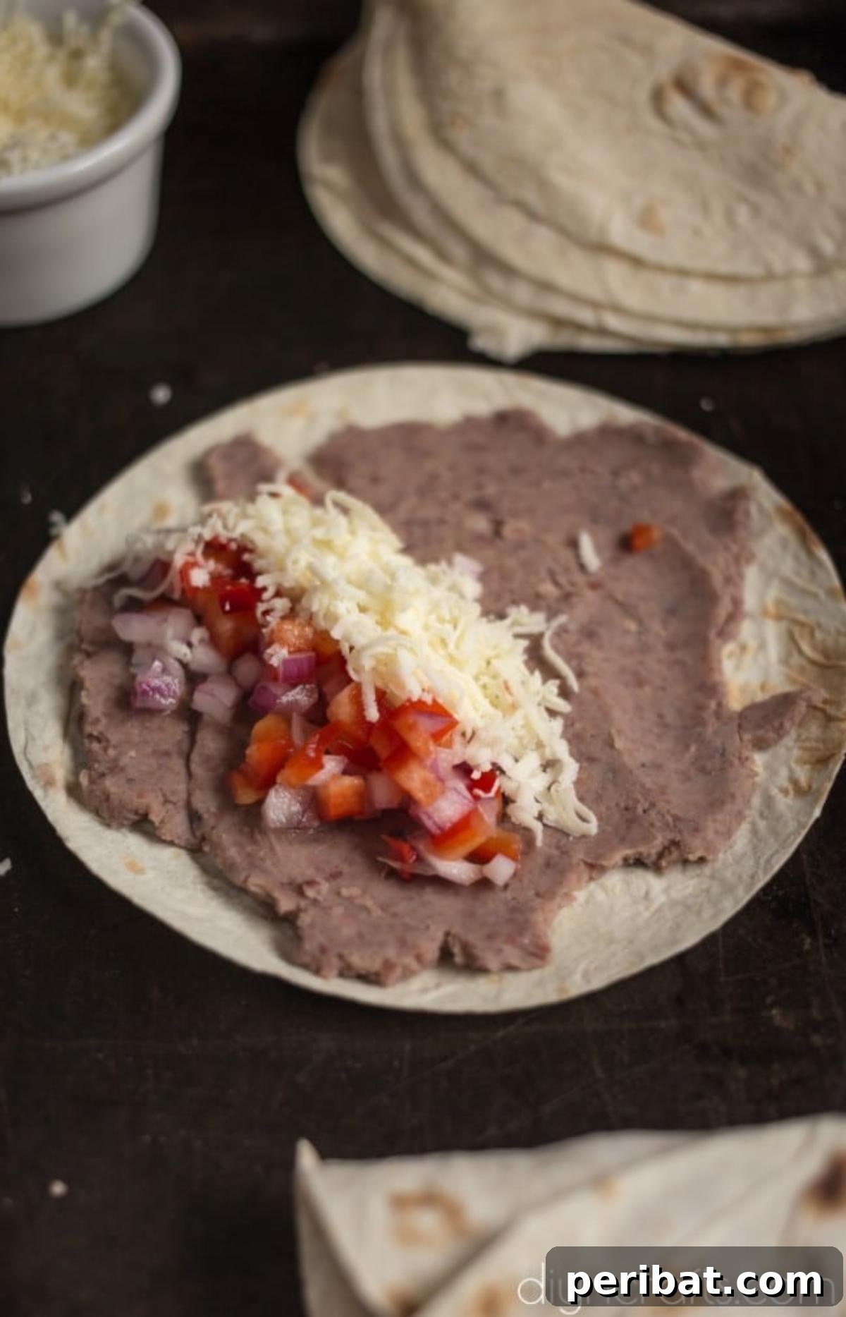 Delicious Black Bean Flautas A Quick and Easy Appetizer 5 Layer tortillas with beans, fresh salsa mixture, and shredded cheese.