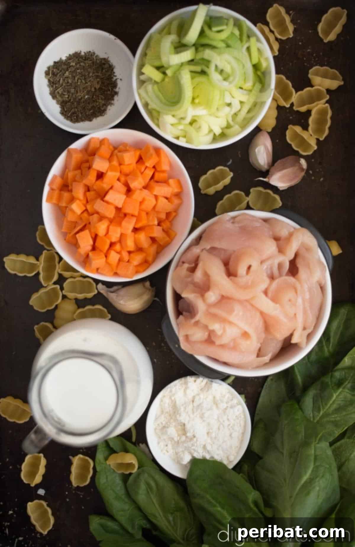 All the fresh ingredients for Chicken Gnocchi Soup laid out on a wooden cutting board.
