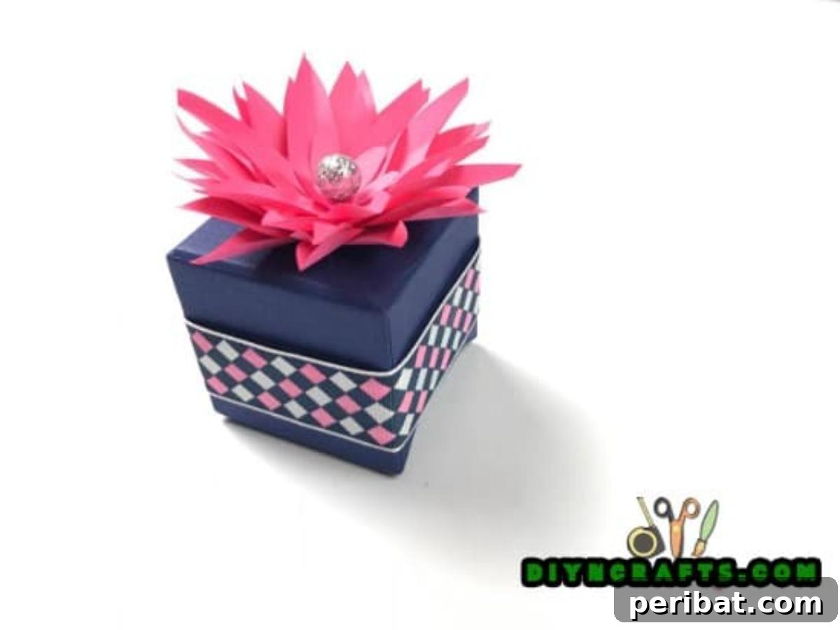 Finished decorative paper gift box topper with a sparkling center.
