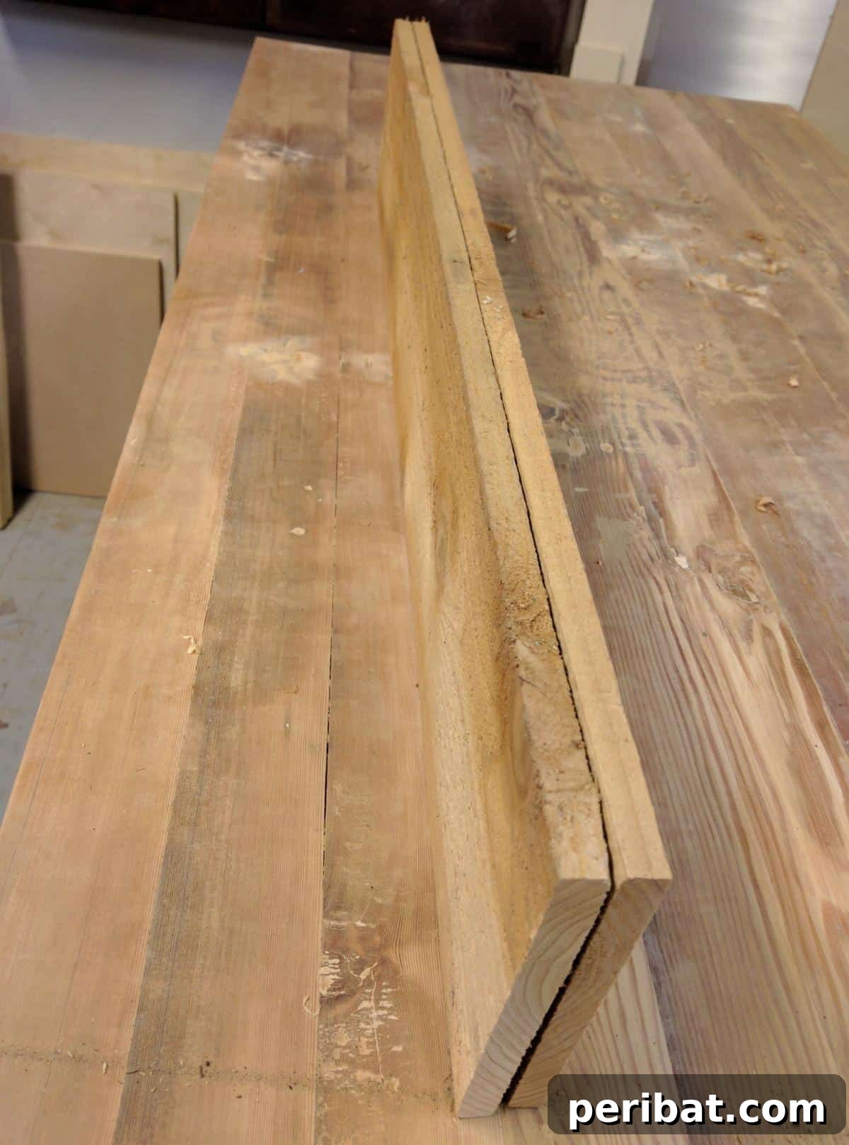 A wooden plank cut to size and sanded smooth, with rounded corners, ready for custom features.