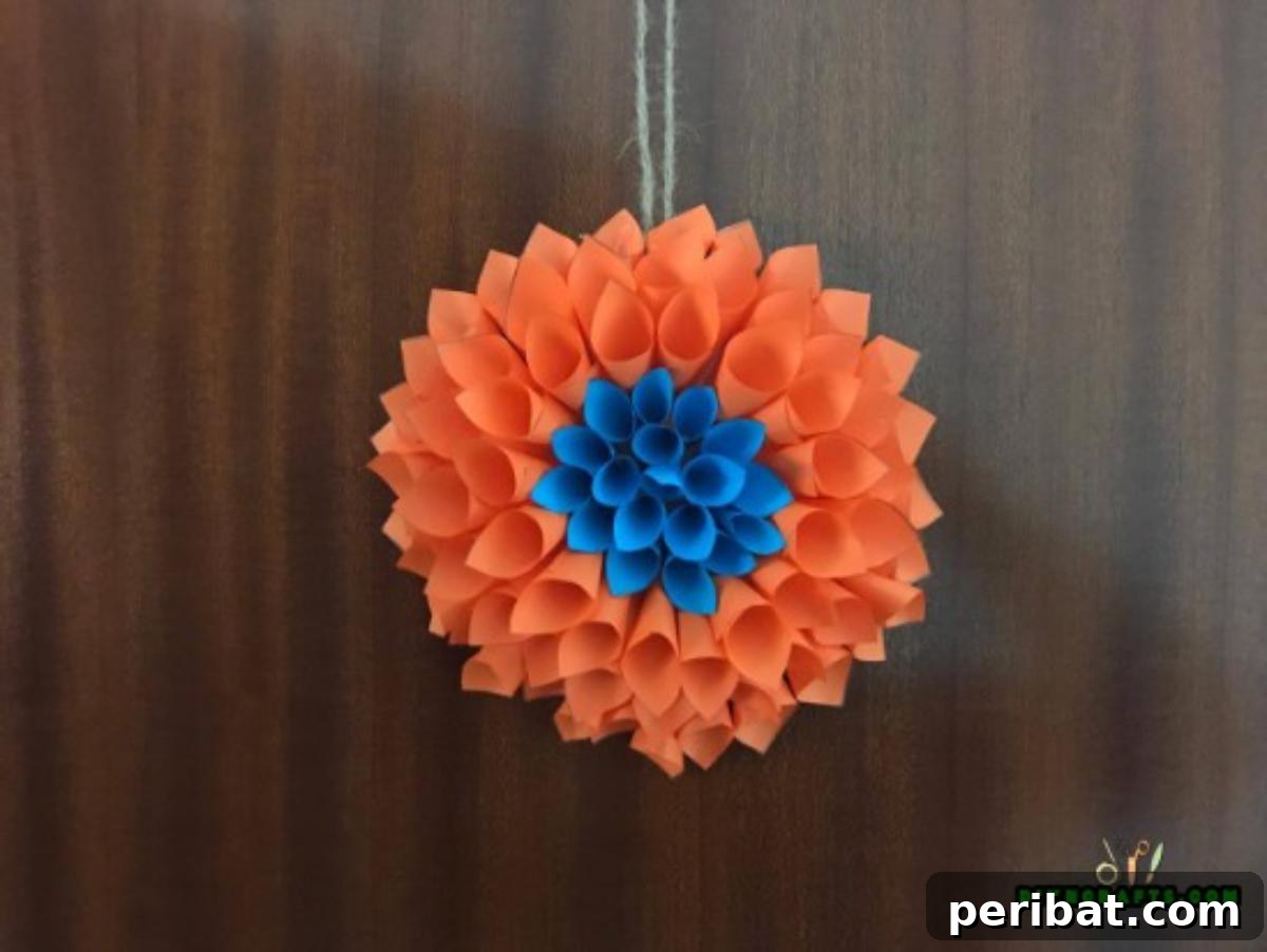 Displaying the finished handmade paper flower wreath on a wall