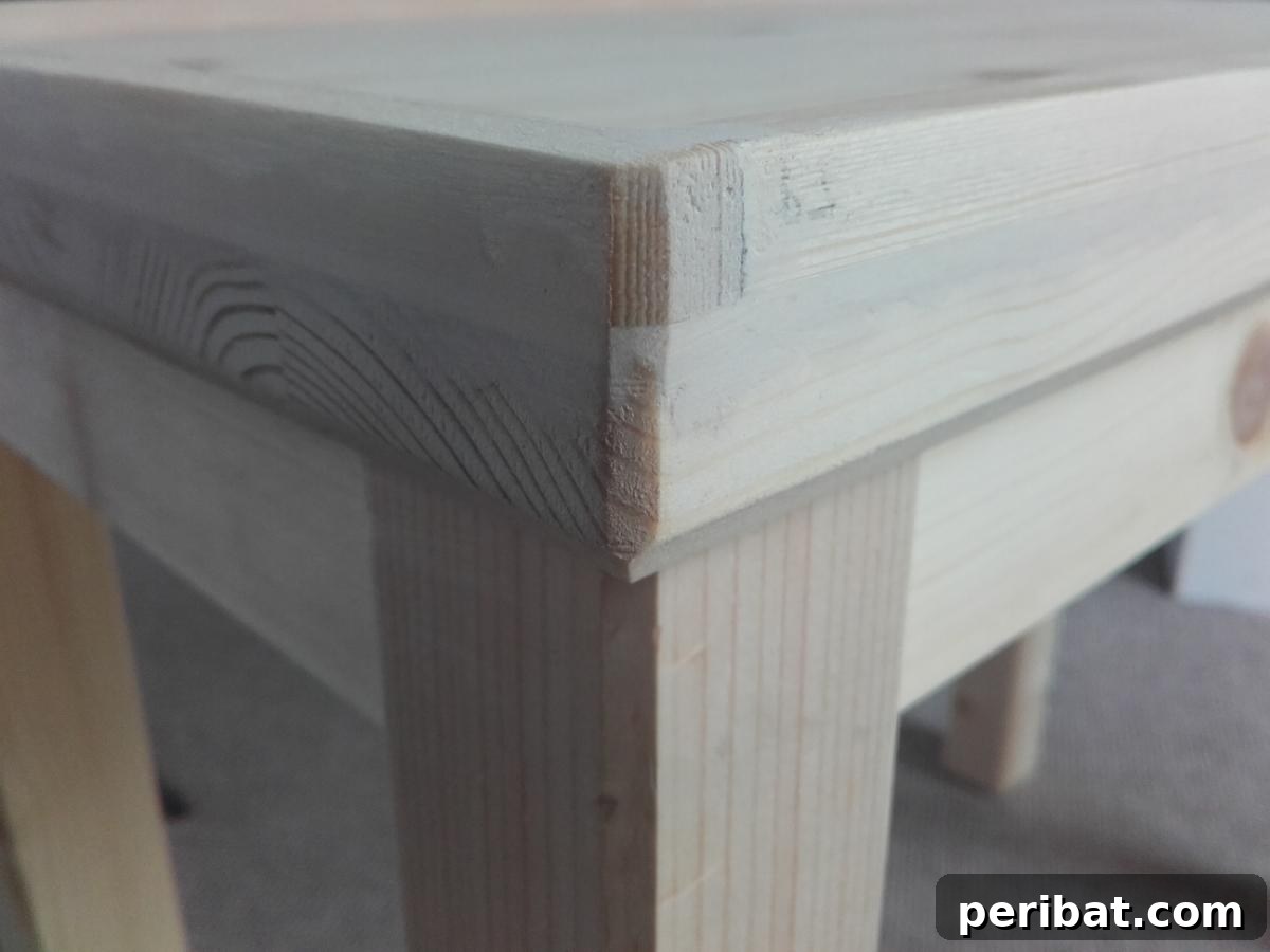 Man Cave Upgrade: Build a Vibrant Bottle Cap Table 5 Wooden IKEA table corner after wood filler application and initial sanding, showing preparation for a smooth finish.