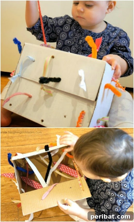 DIY fine motor development tugging box with ribbons and yarn