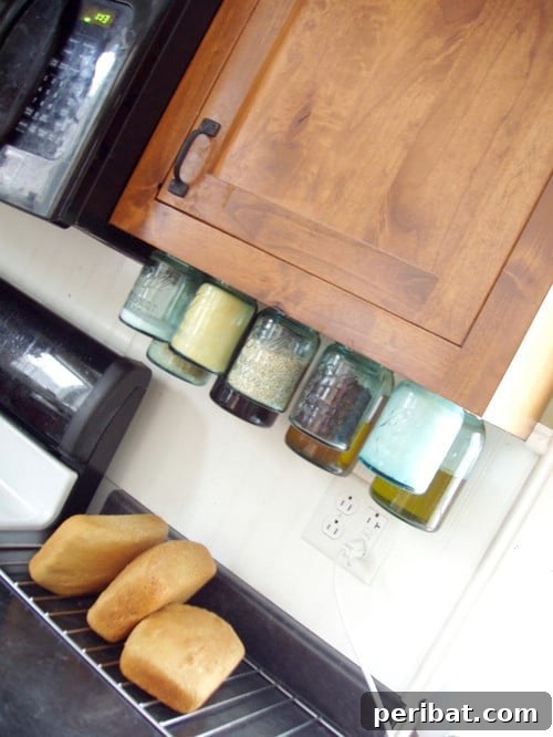 Mason Jars Hung from Cabinets - 150 Dollar Store Organizing Ideas and Projects for the Entire Home