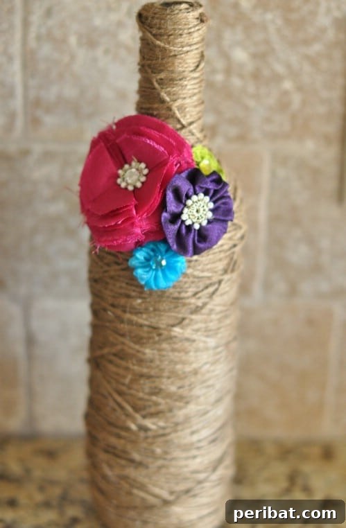 Crafting Rustic Style: Twine Decor for Indoors and Outdoors 5 Decorative twine wrapped glass bottle adorned with a small burlap flower