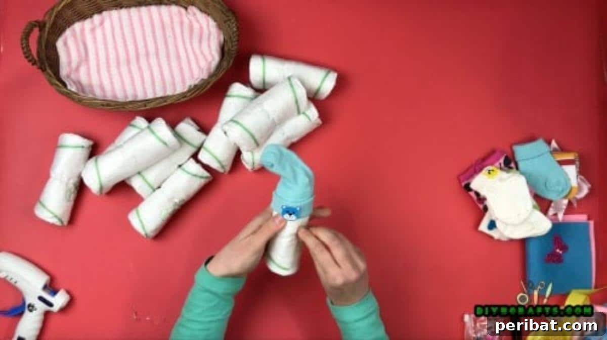 Craft a Diaper Baby Basket for a Perfect Baby Shower Gift 6 Put a sock on top of each one to create a “hat.”