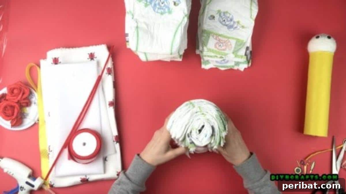 DIY Diaper Butterfly Baby Shower Gift 6 Roll up a single diaper, and then add a second diaper around it. Layer them up until you get about 6 diapers.