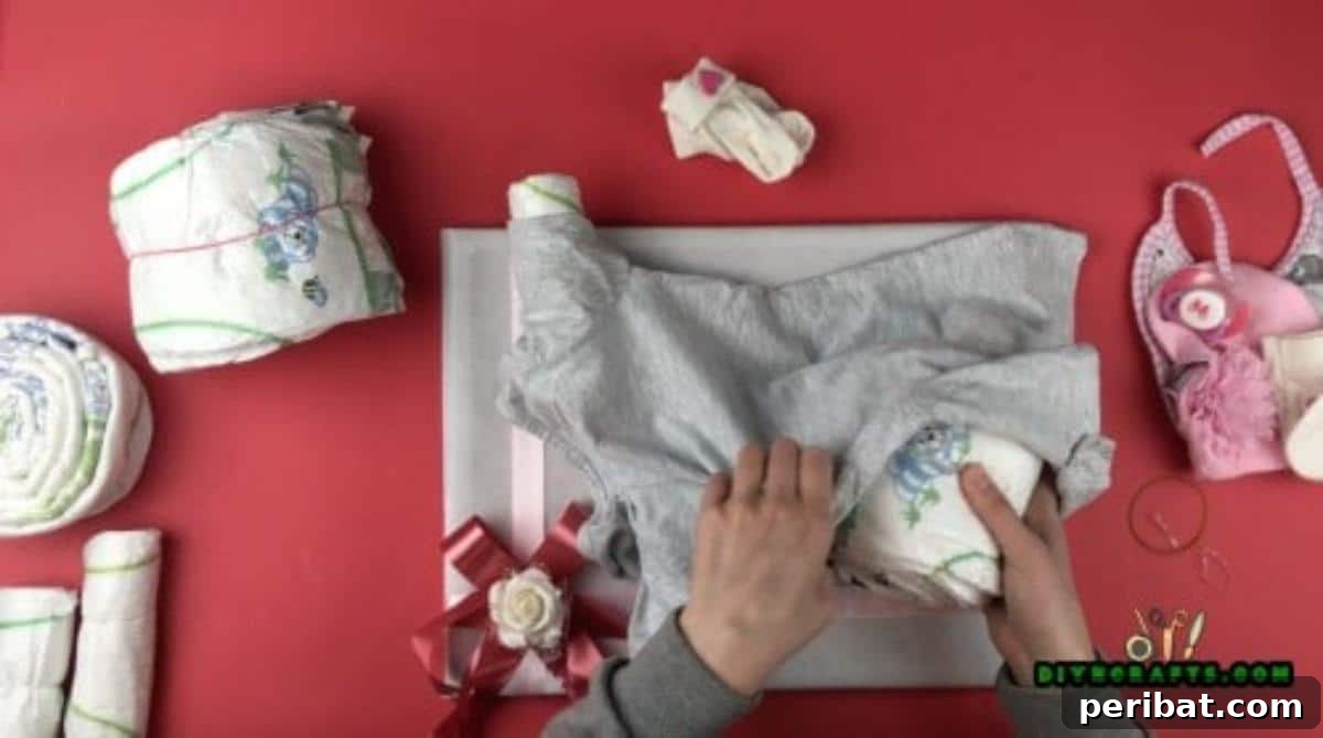Crafting an Adorable Diaper Baby Gift 7 A diaper baby mid-assembly, with the chest and bottom diaper bundles being gently inserted into the baby coverall, creating the main torso of the figure.