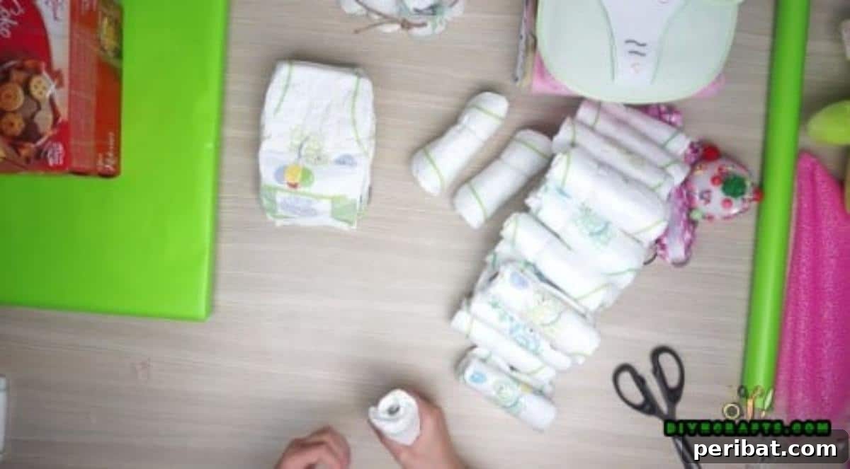 Roll up individual diapers and place them snugly around the perimeter of the chocolate box, under the rubber band, to form the boat's hull.